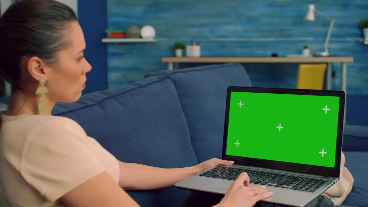 Freelancer using laptop computer with mock up green screen