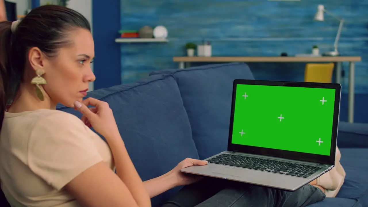 Business woman working on laptop computer with mock up green screen