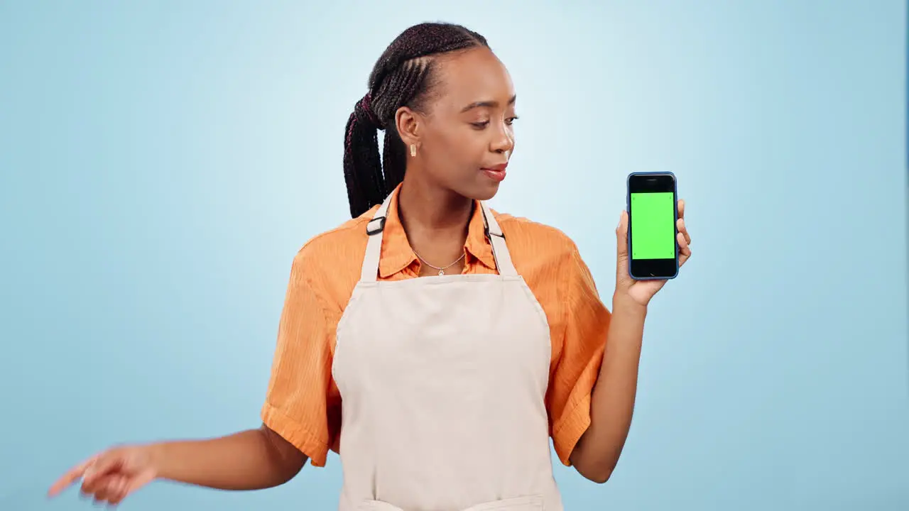 Black woman waitress and phone pointing to green