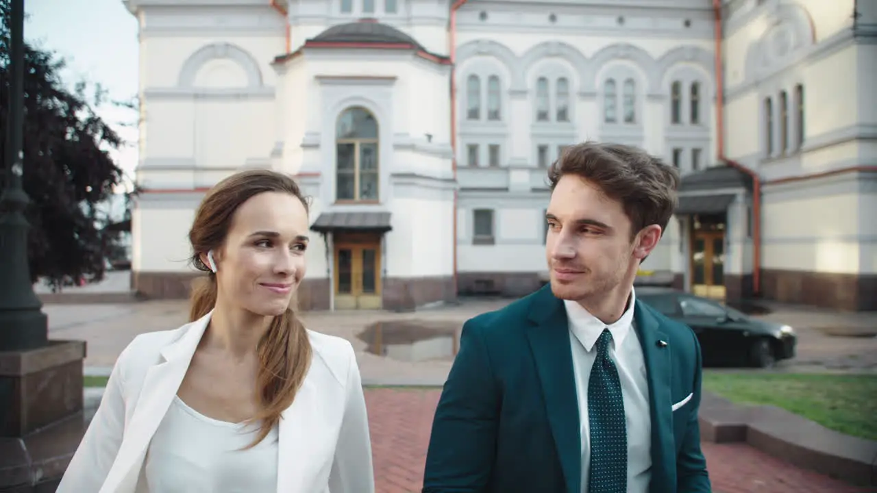 Elegant business couple smiling to each other in city People walking outdoor