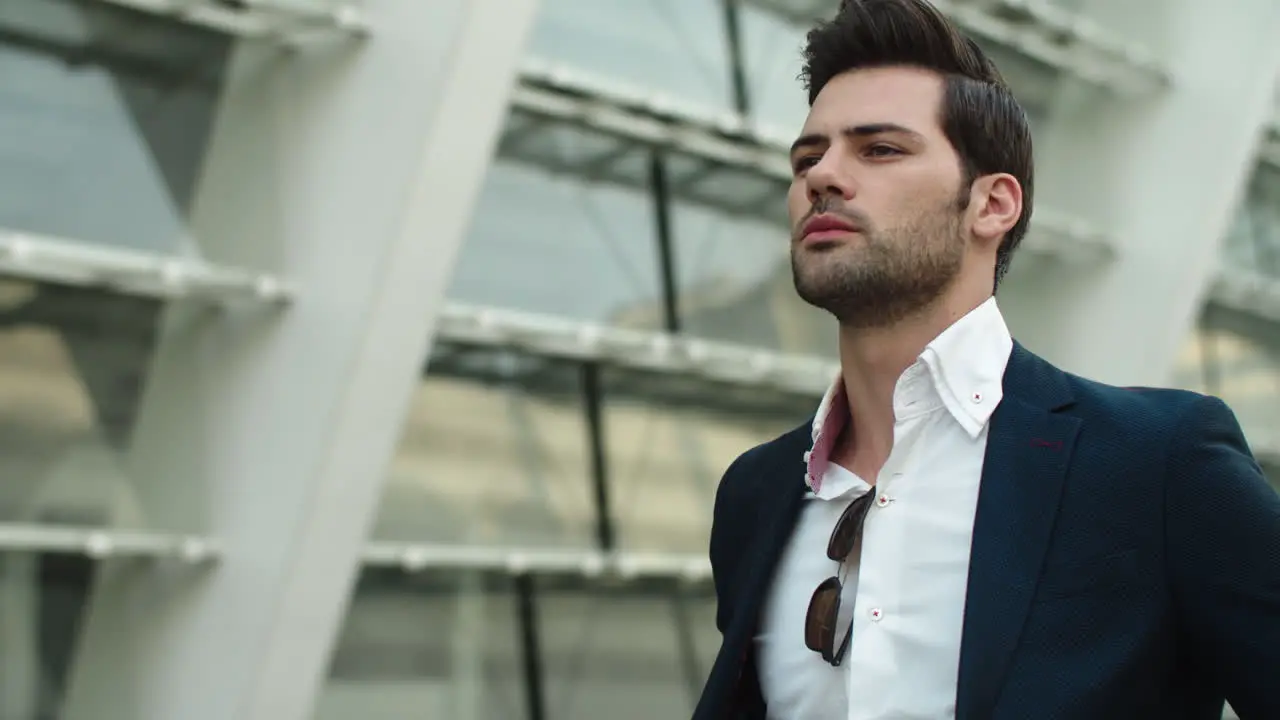 Portrait man looking away at street Businessman checking time on watch outdoors