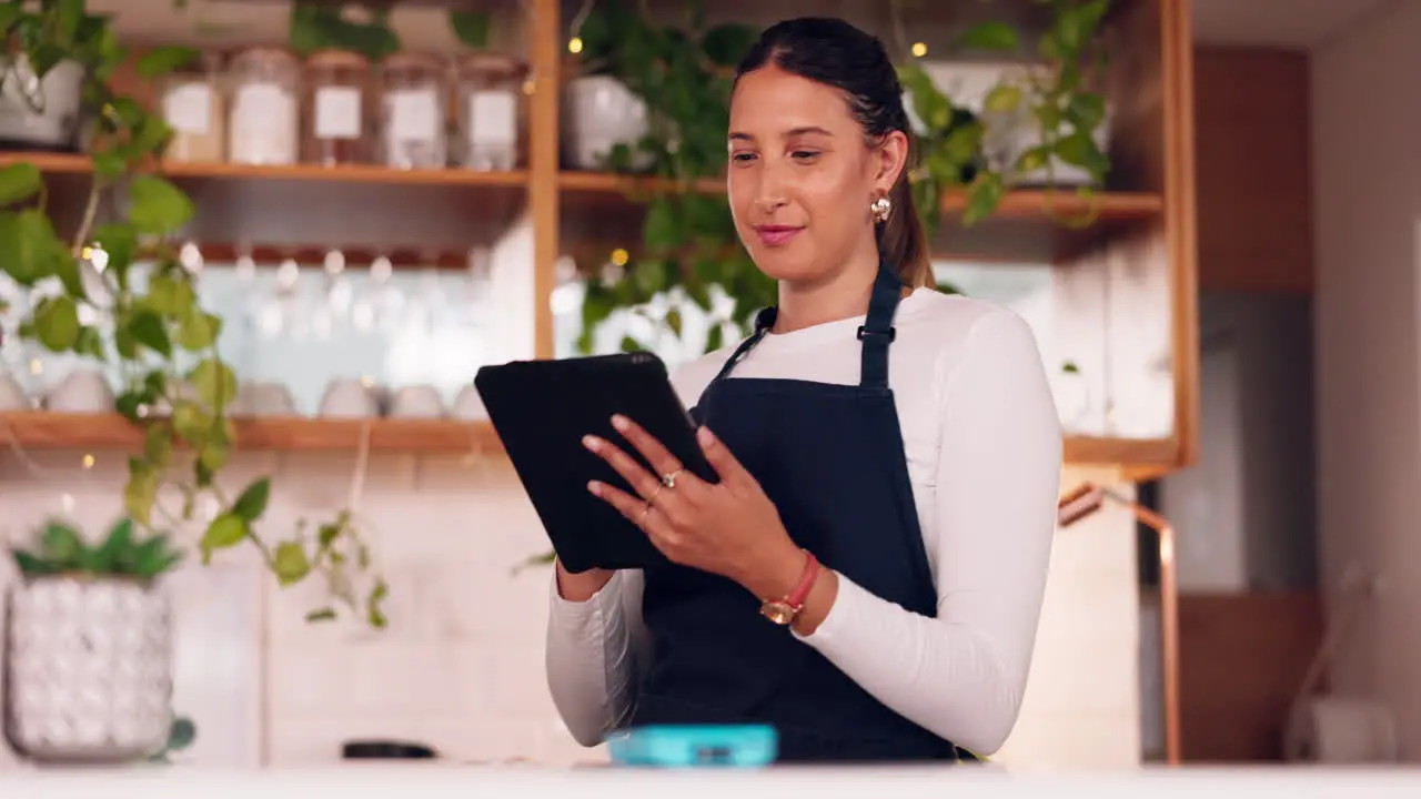 Happy woman or barista on tablet for small