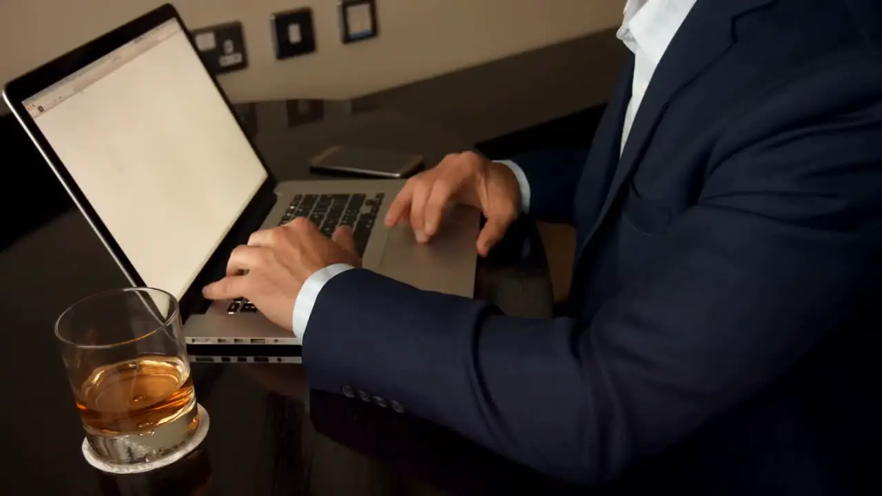 Mid section of businessman working on laptop 4k