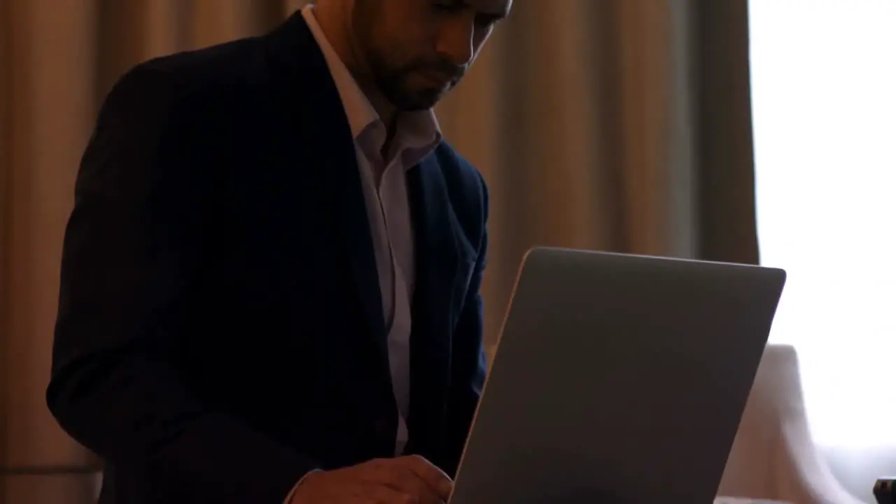 Businessman using laptop on bed 4k