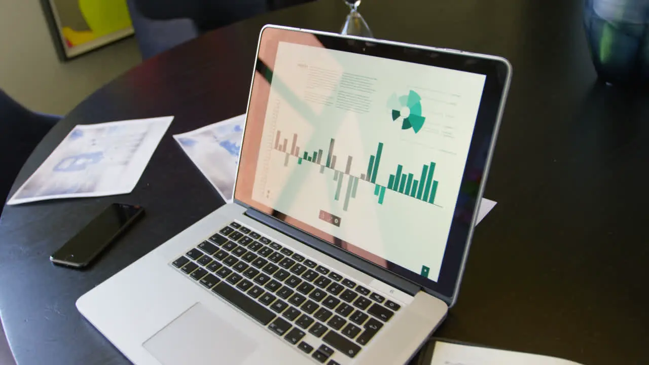 Close-up of laptop mobile phone and documents on the table in conference room of modern office 4k