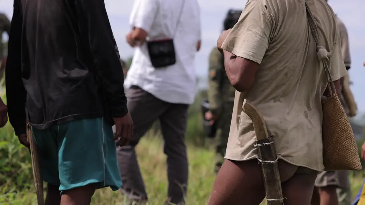 Triba local people in South Asia meeting outdoor unrecognizable faces carring machete