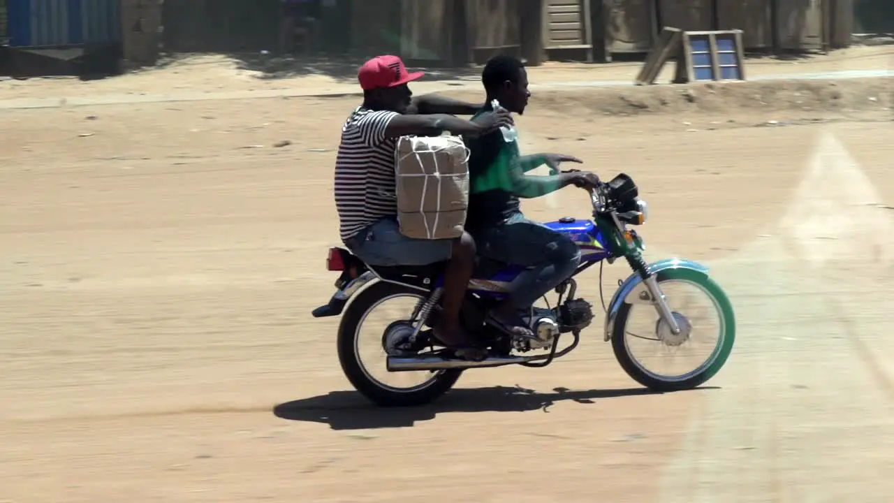 two men on a motorcycle in Africa