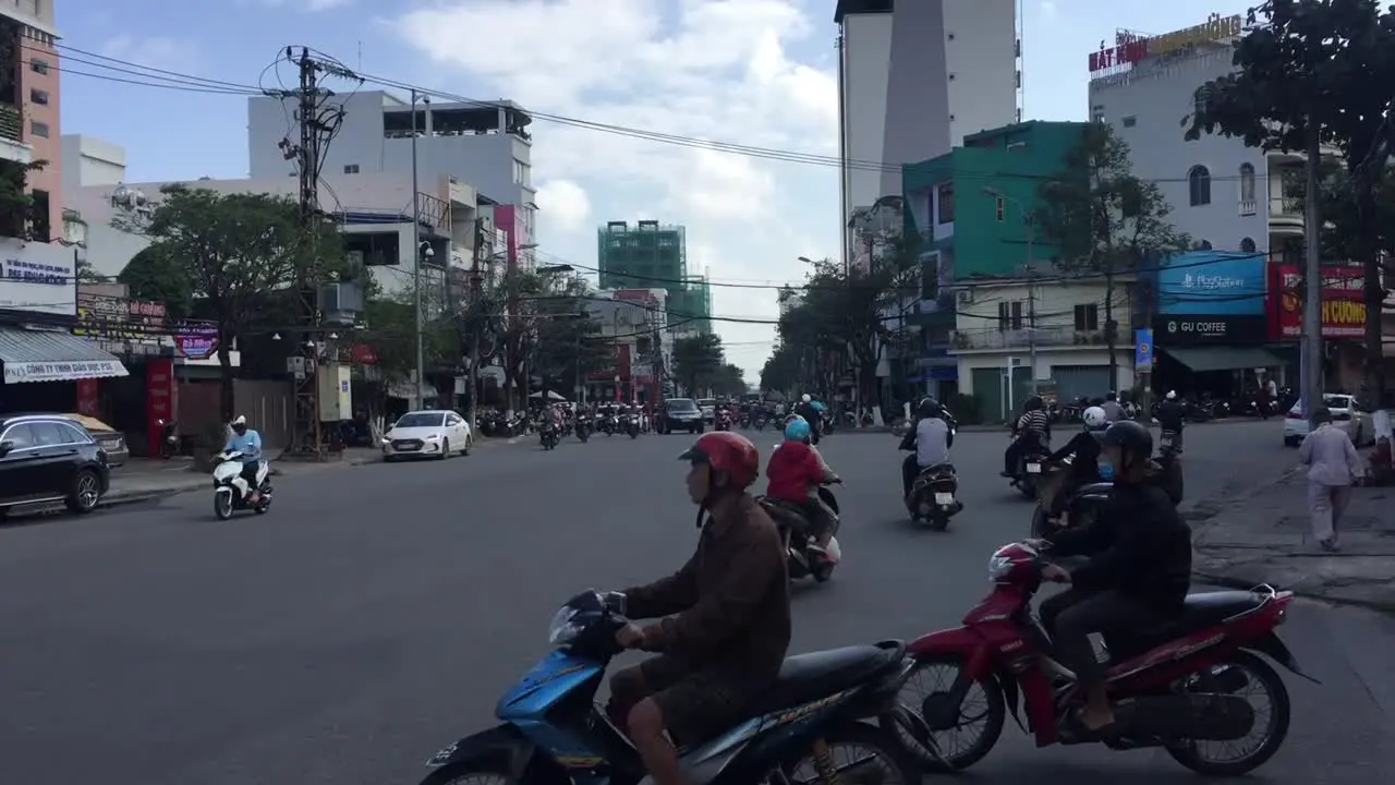 wild intersection in Da Nang Vietnam With Cars Bikes and People