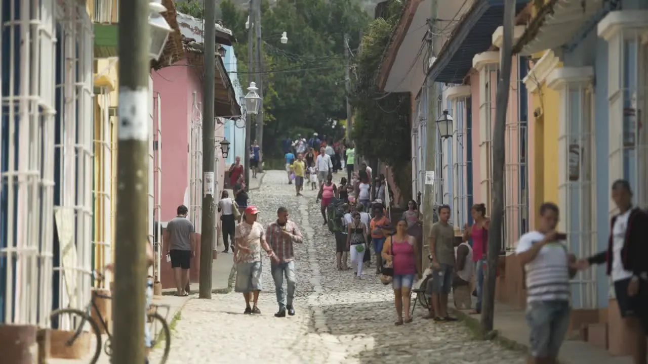 day shot of people walking in Cuba Havana streets  tourists enjoy holiday summer hot sunny day small buildings sunny day culture