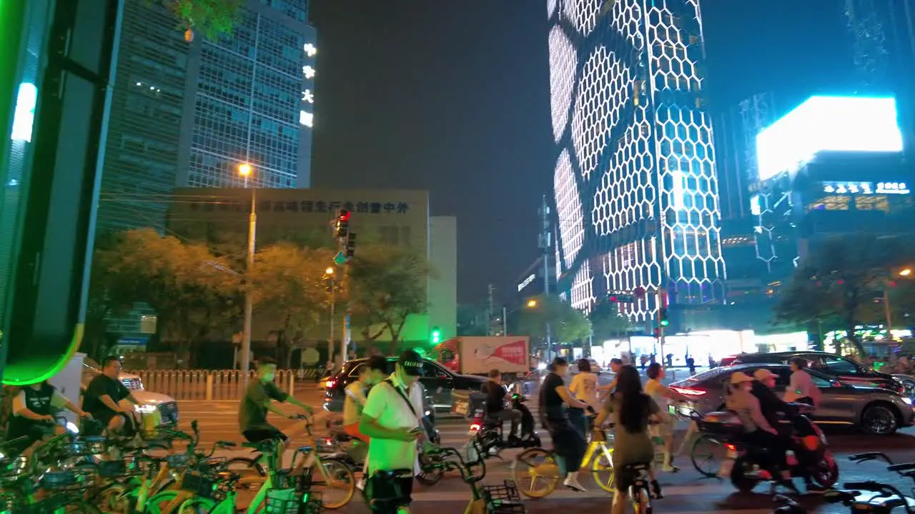 Beijing Sanlitun 4k busy streets at night with people riding bikes and beautiful skyline