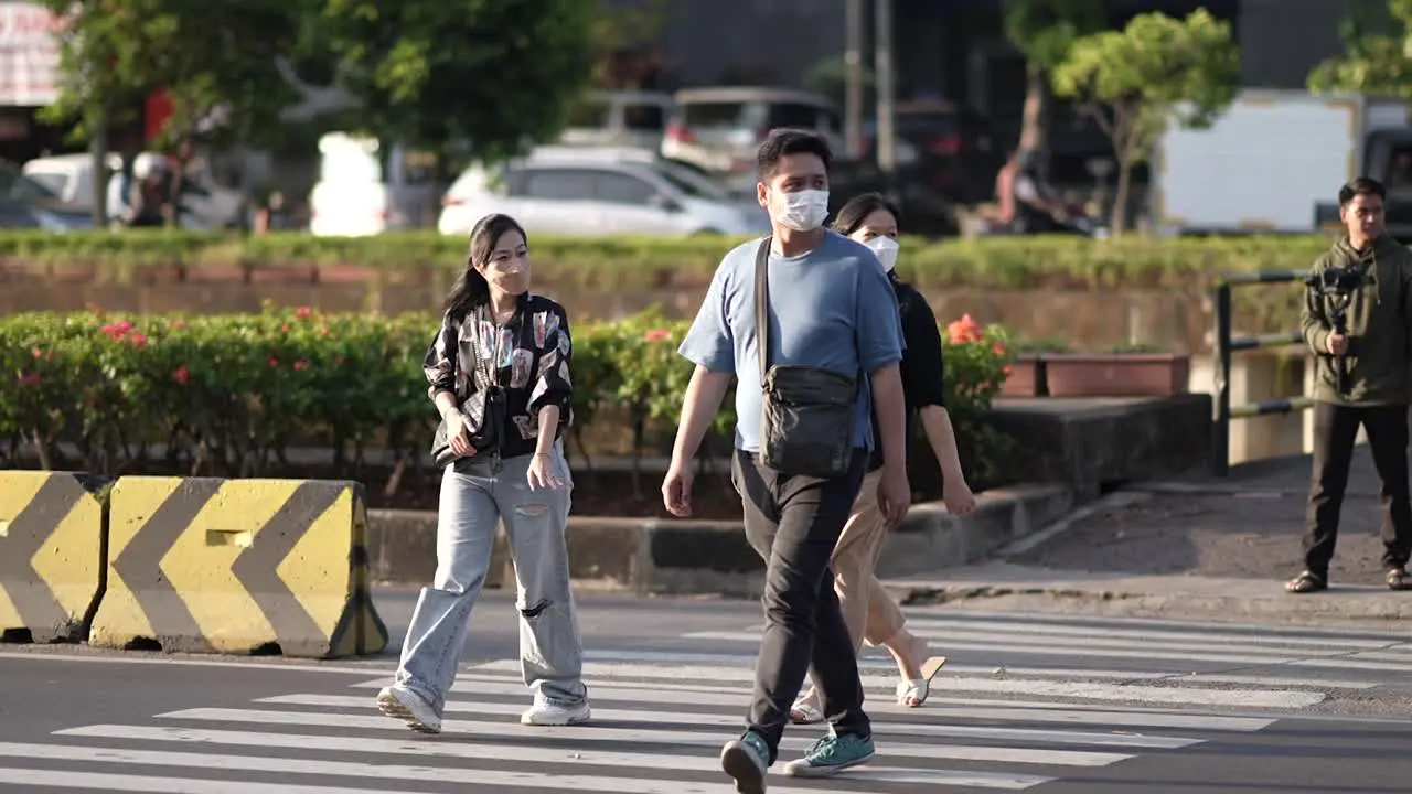 people crossing the street at the pecenongan busway stop Central Jakarta Indonesia