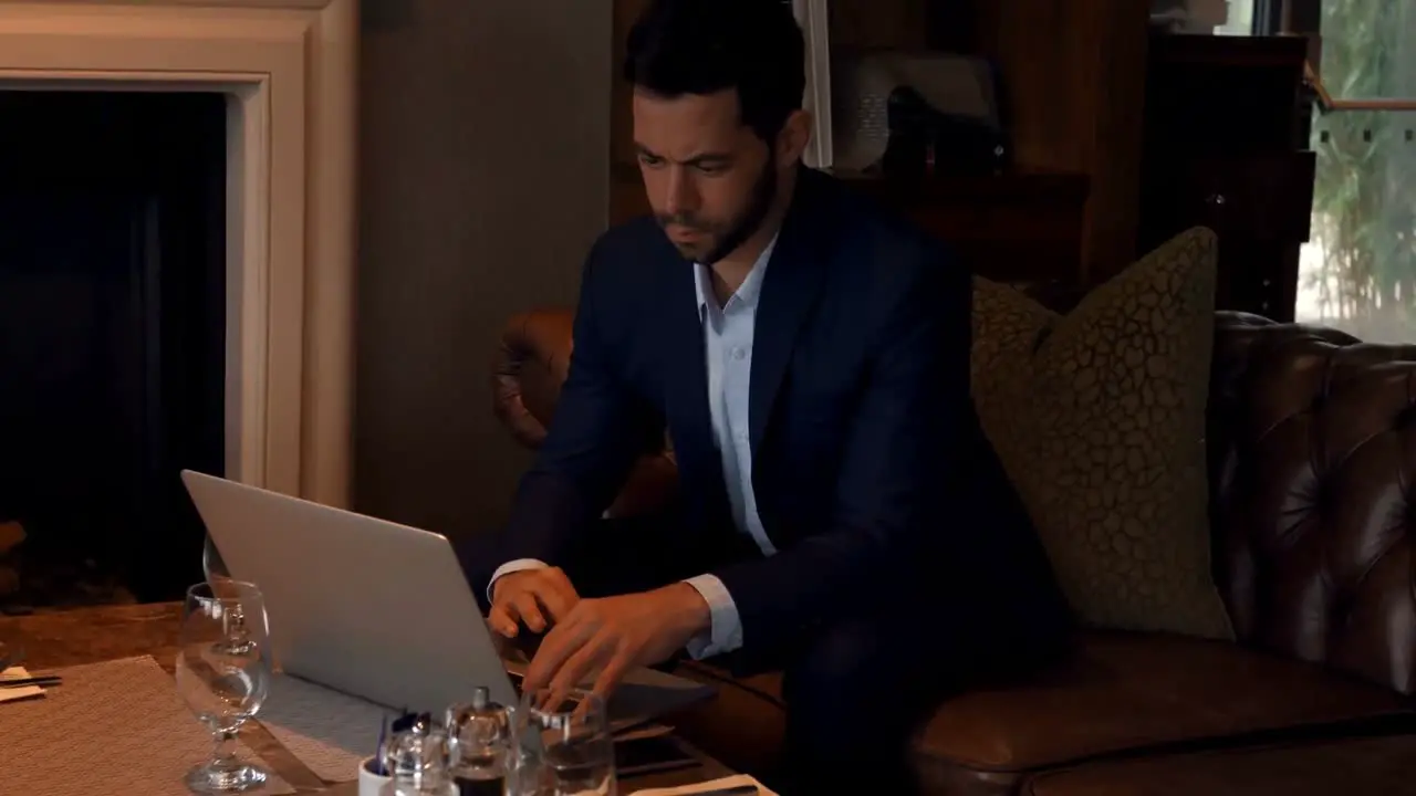 Businessman using laptop at dinning table 4k