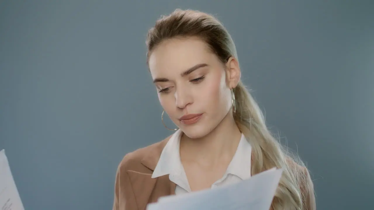 Thoughtful business woman looking documents Serious person holding papers