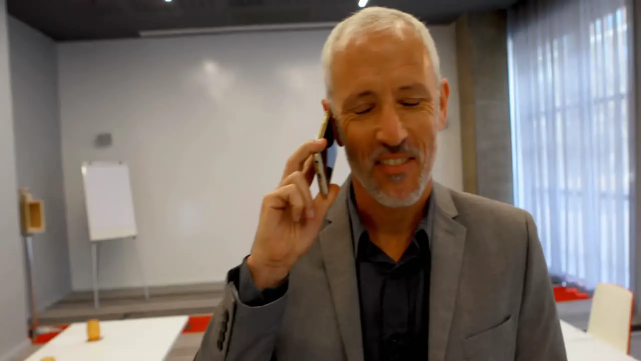 Businessman talking on mobile phone in hotel 4k