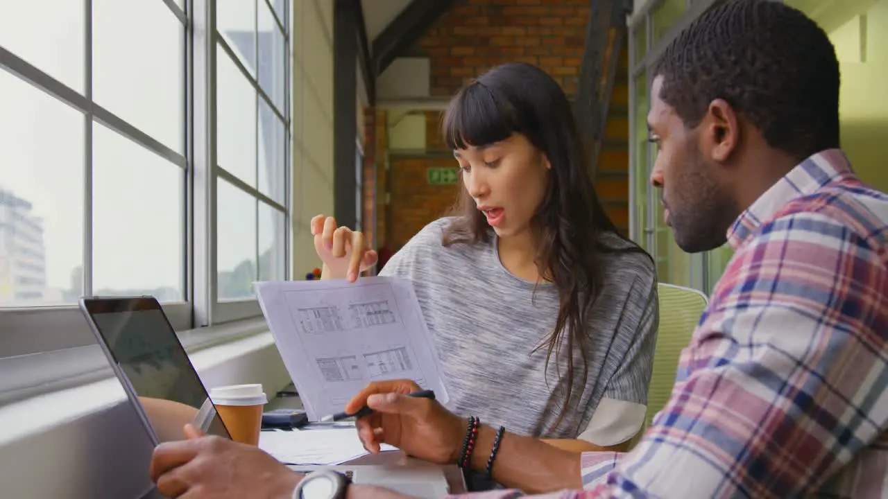 Business people working together on a document in office 4k