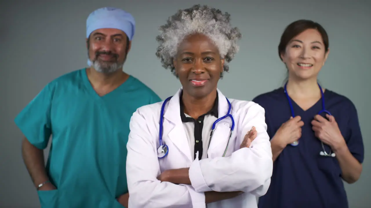 Three Approachable Middle Aged Doctors Smiling Portrait