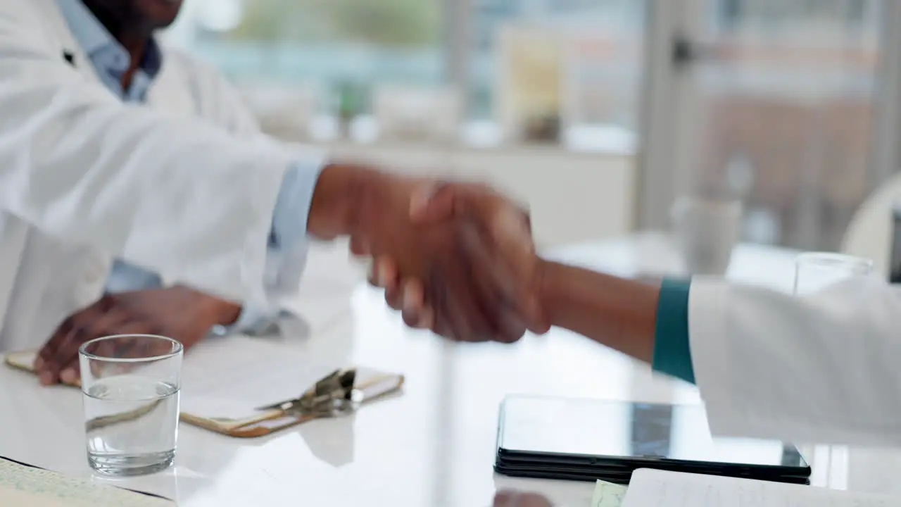 Doctors handshake and medical team in hospital