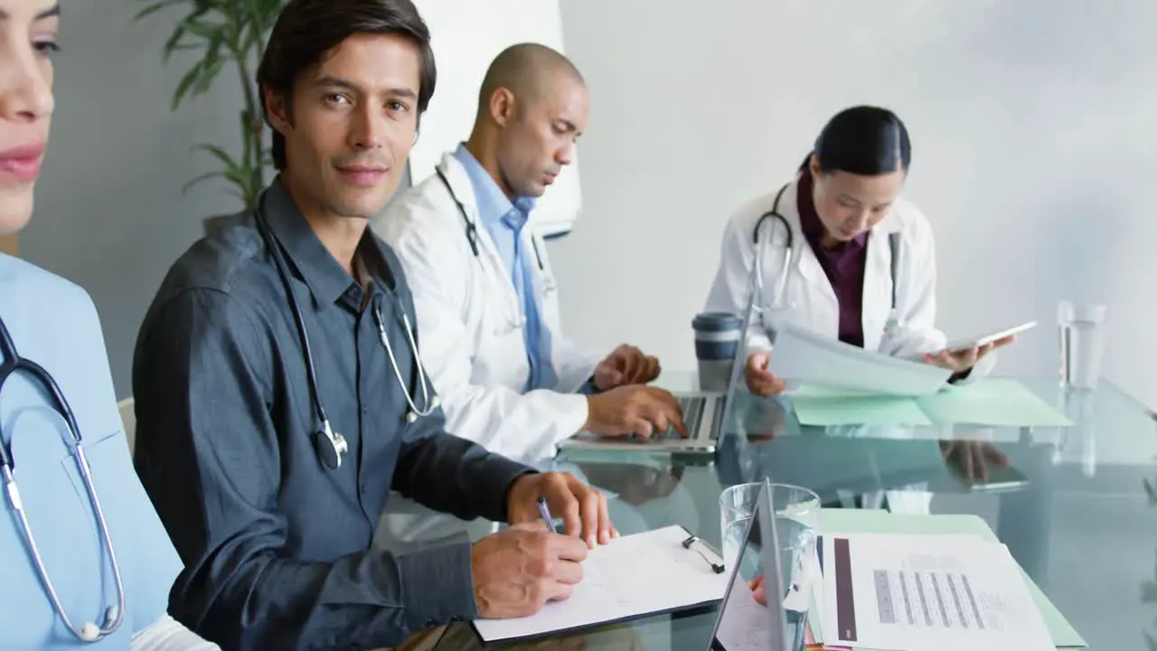 Young doctors sitting at a table working together 4k