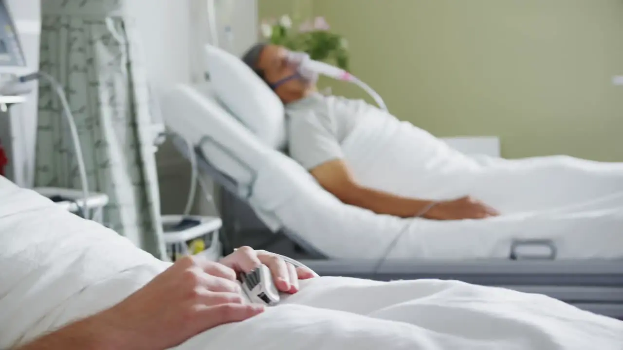 Two male patients lying in hospital beds 4k