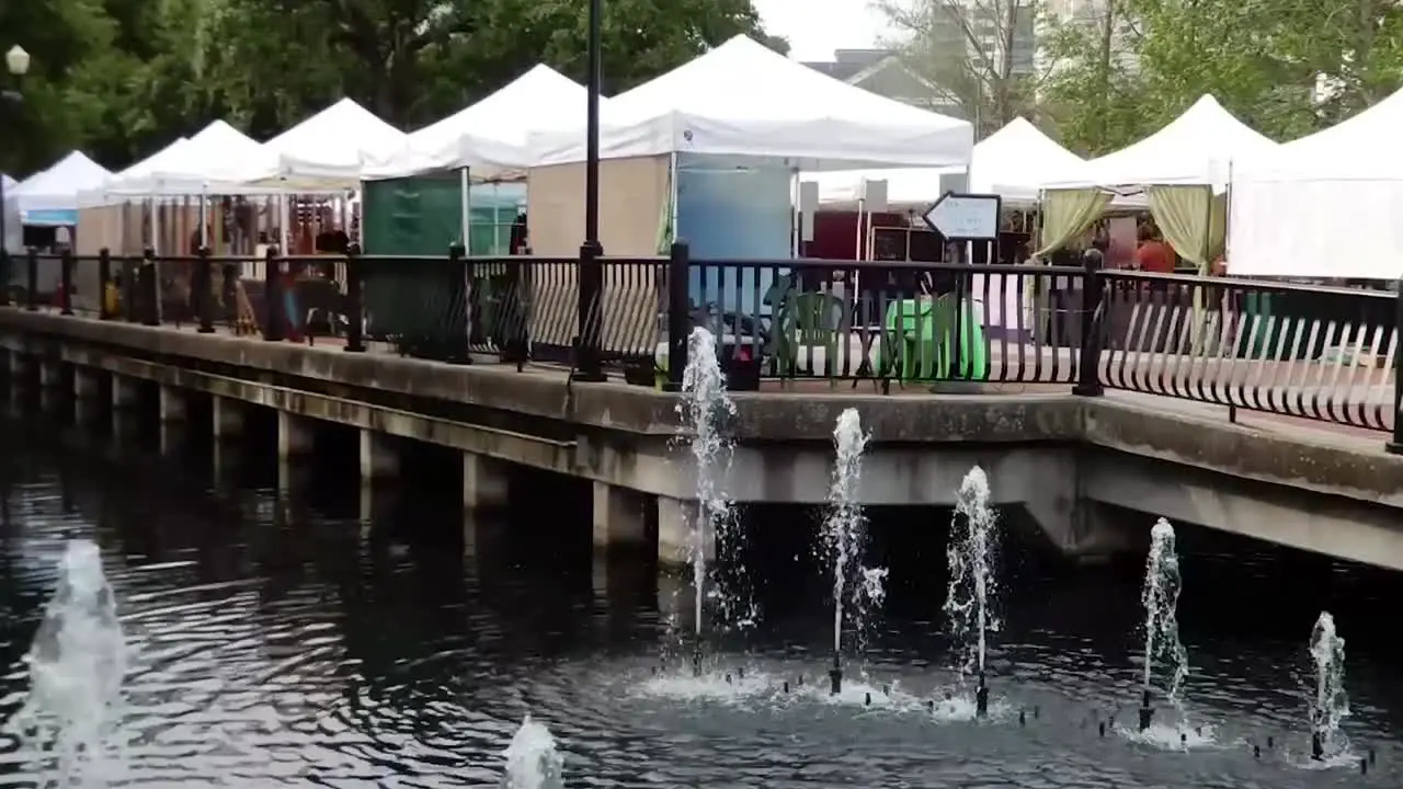 People are busy shopping and enjoying this open air market