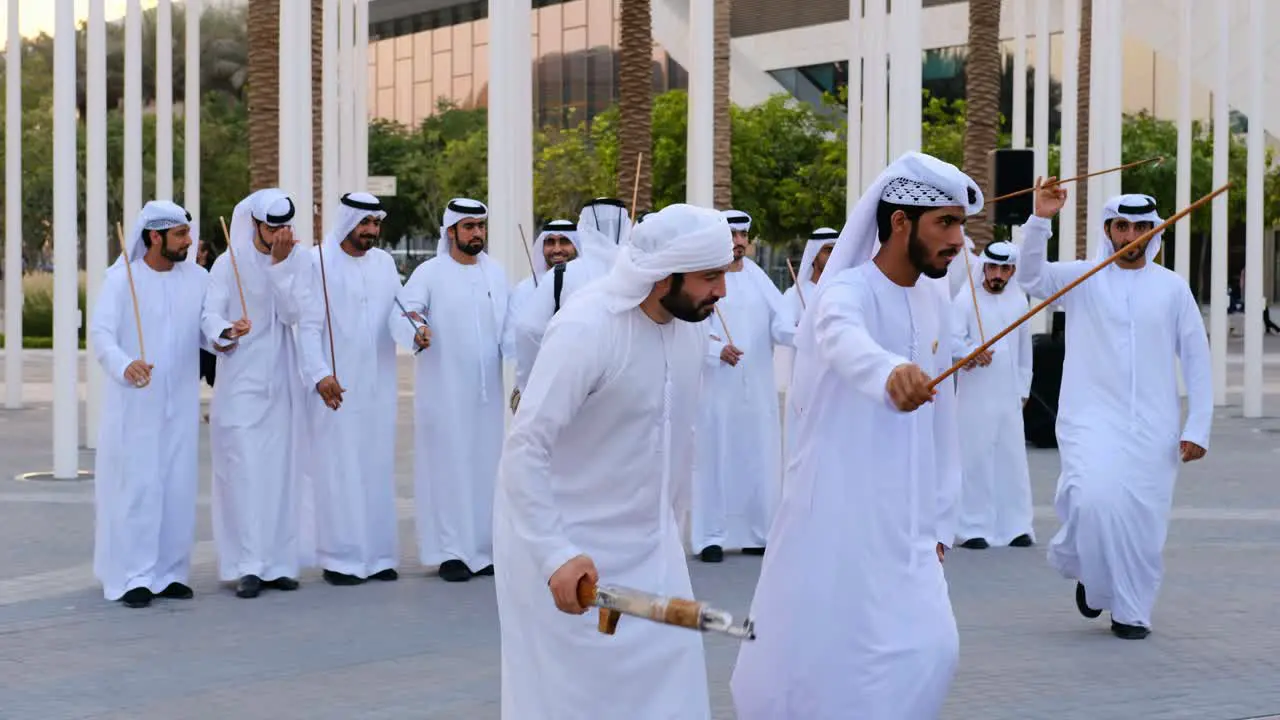 Emirati men on Kandura Dish Dash dancing on traditional song at EXPO 2020