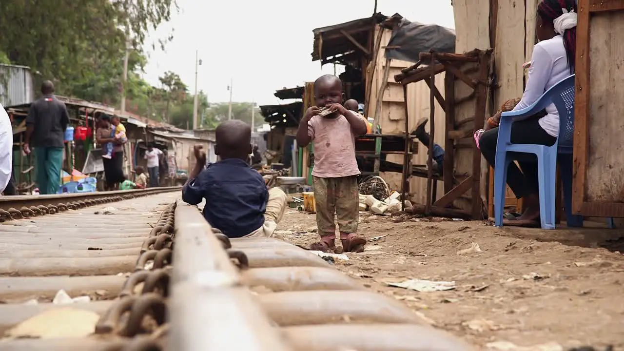 Toddlers playing on the railway in Kibera Nairobi Kenya