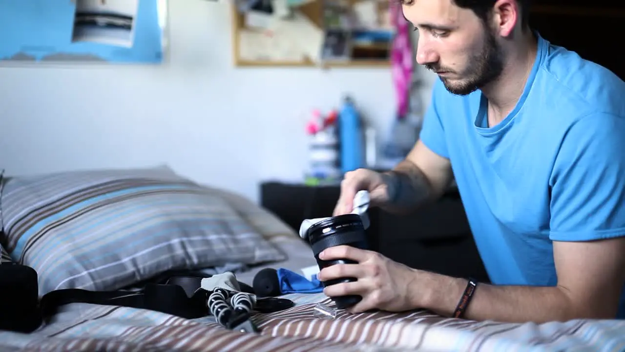 Photographer cleaning his lenses at home static shot