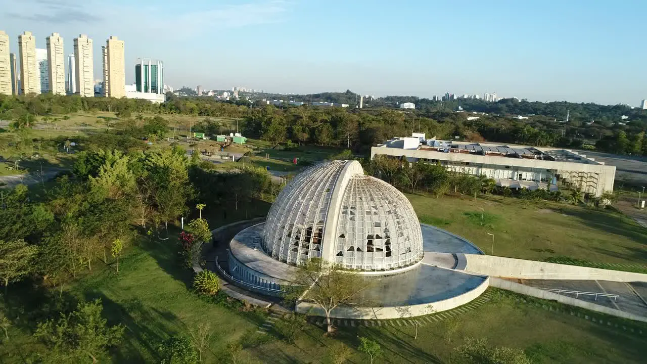 Drone rotating from left to right in low flying nursery in public park full of lush vegetation tranquility nature calm peace in 4K resolution