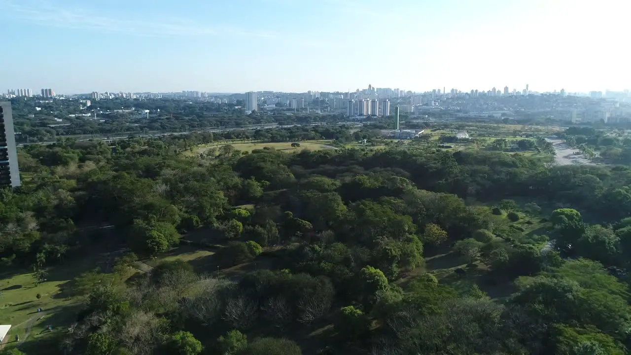 Drone footage with moving forward showing vegetation in the middle of a public park with lush nature sport leisure health in 4 resolution