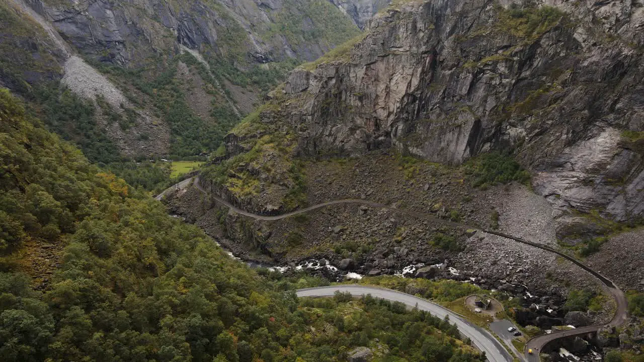 A mountain road and river goes trough a beautiful valley in Western Norway