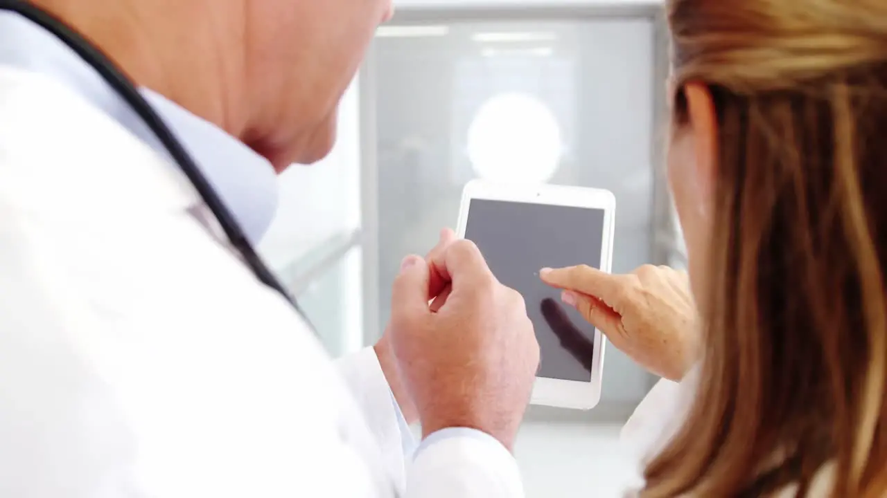 Doctors using digital tablet