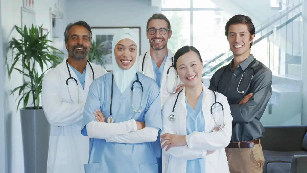 Doctor smiling to camera in hospital corridor 4k