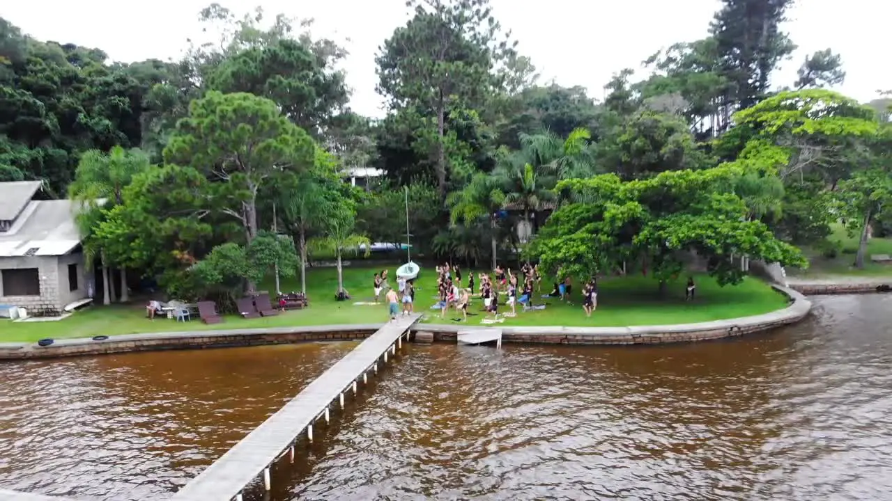 Aerial Pan Drone Footage of Yoga Practitioners on Nature Lake in Florianopolis Brazil