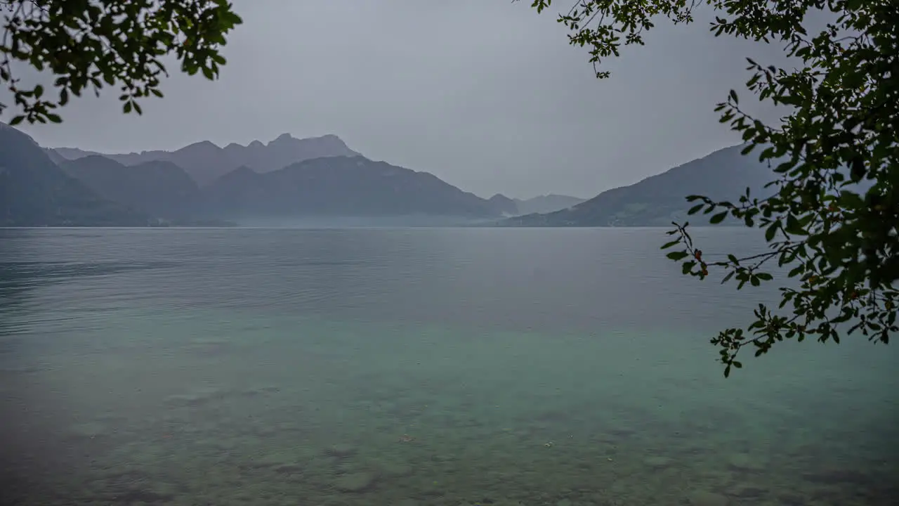 View over pristine lake surrounded by mountains Attersee Austria