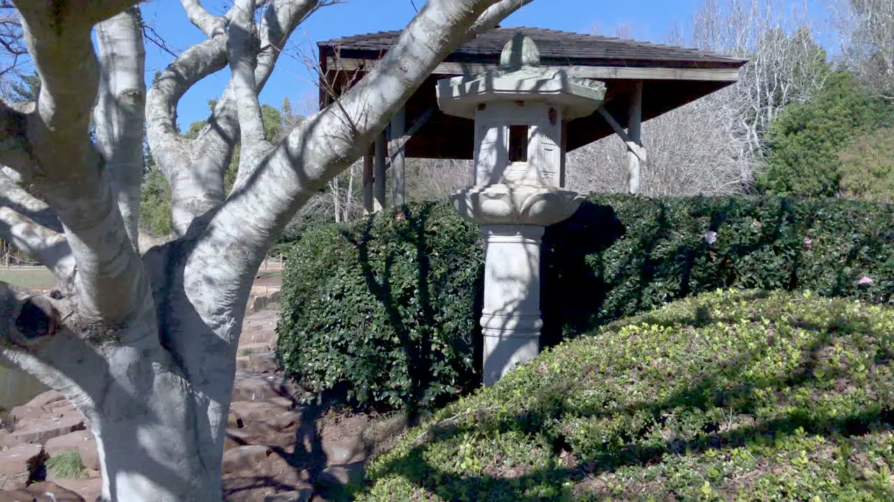 Tilt shot to Japanese lantern in gardens of Ju Raku En Japanese Garden Toowoomba Australia