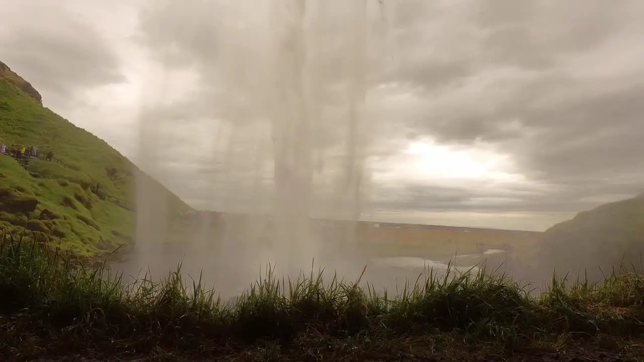 What is seen behind Seljalandsfoss Waterfall