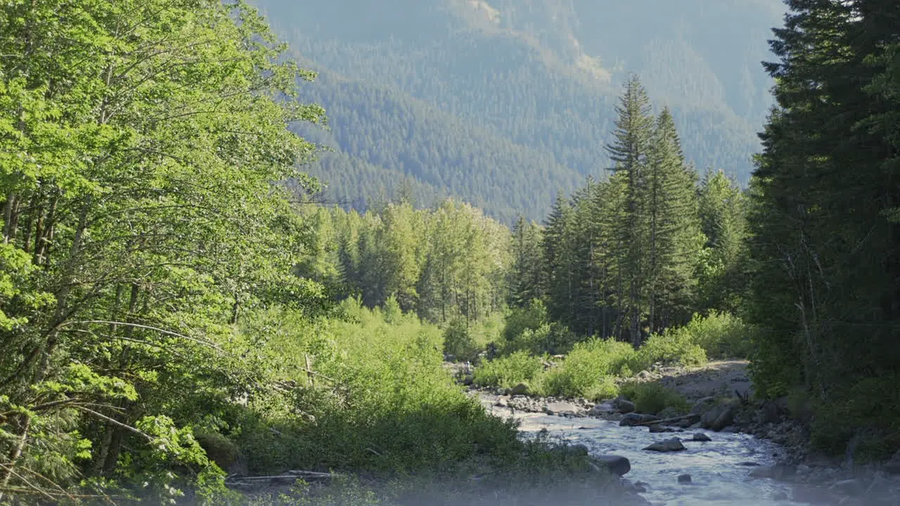 Wide Shot frame within a frame dolly in to river and mountain landscape