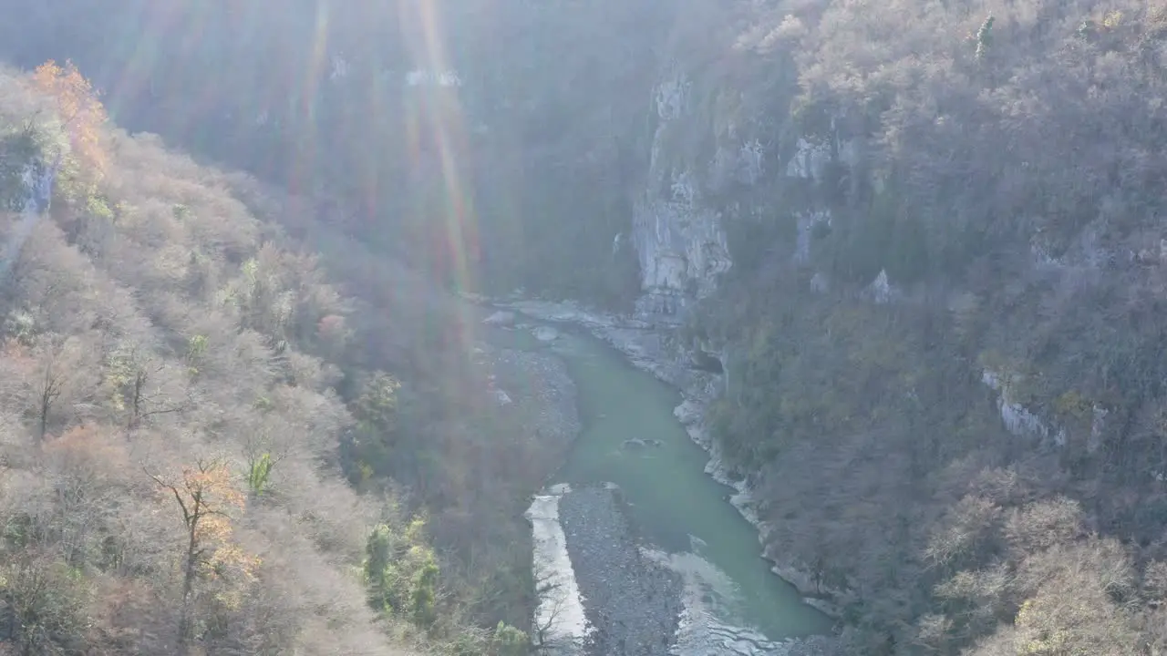 Sunrays on icey river in valley during winter Kutaisi Georgia