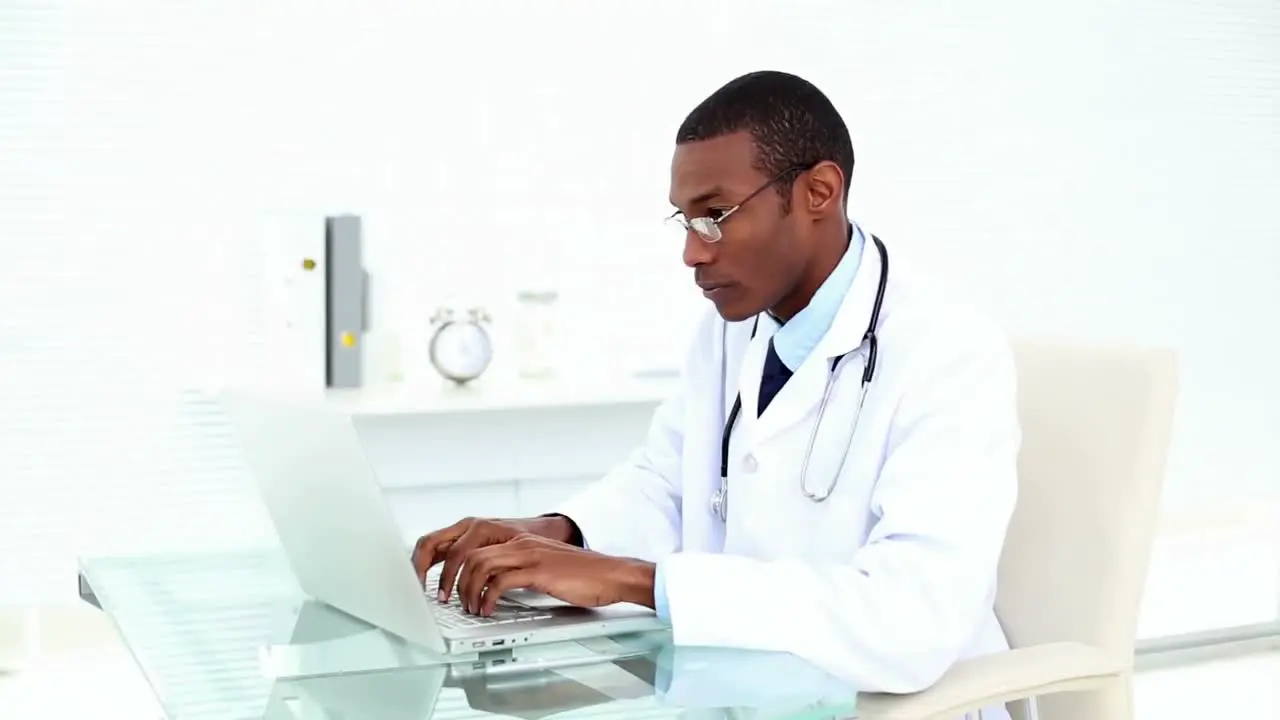 Concentrating doctor working on his laptop