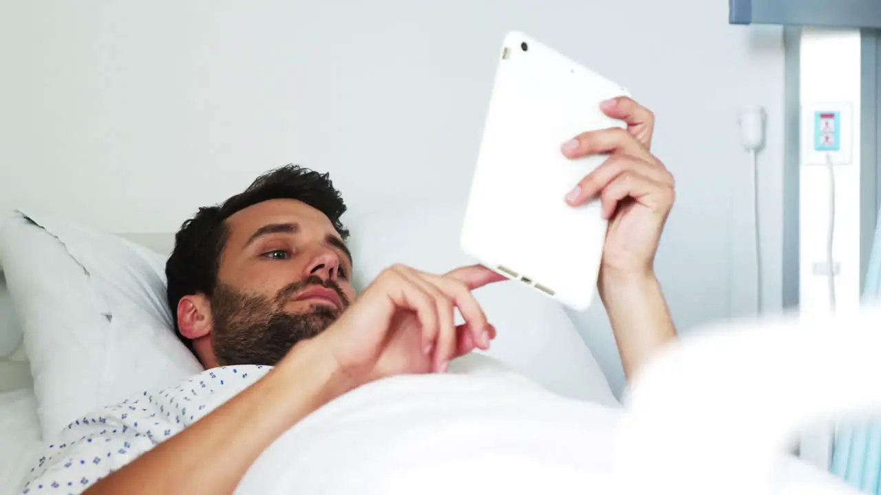 Male patient using digital tablet