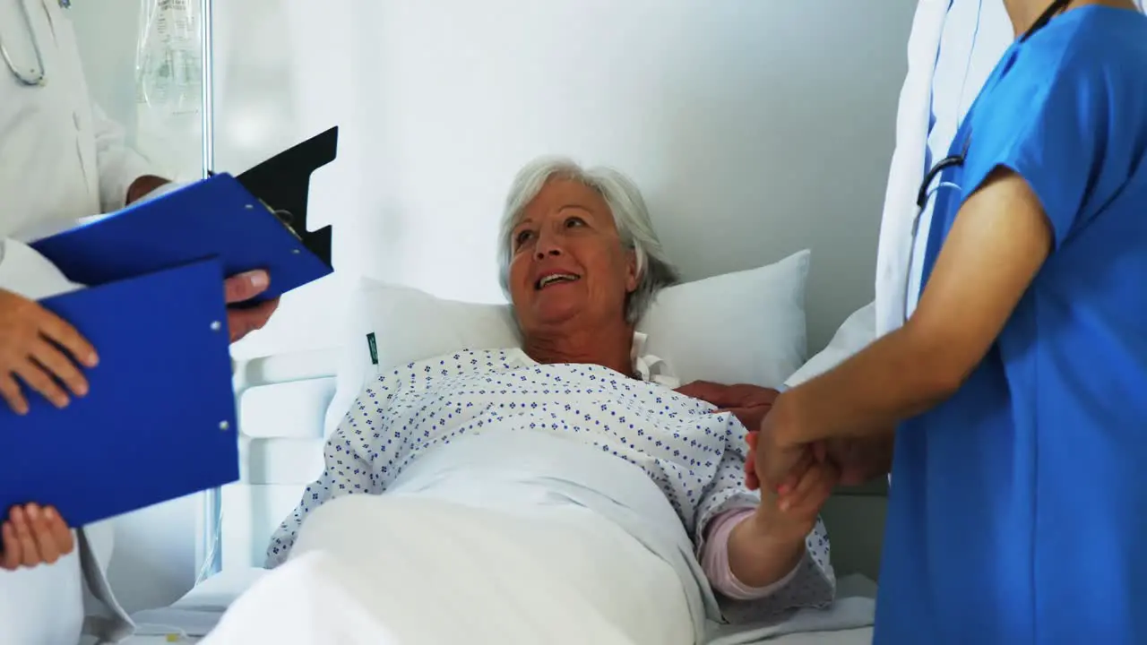 Group of doctors relieving old woman