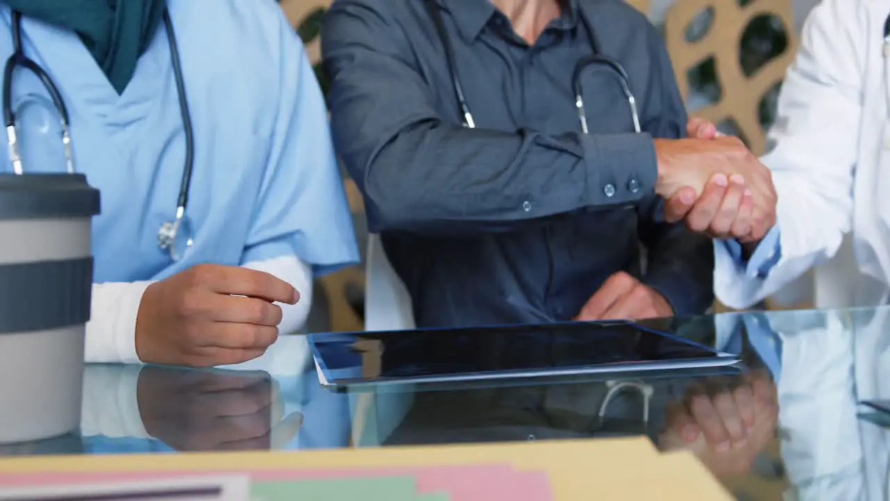 seated doctors shaking hands 4k