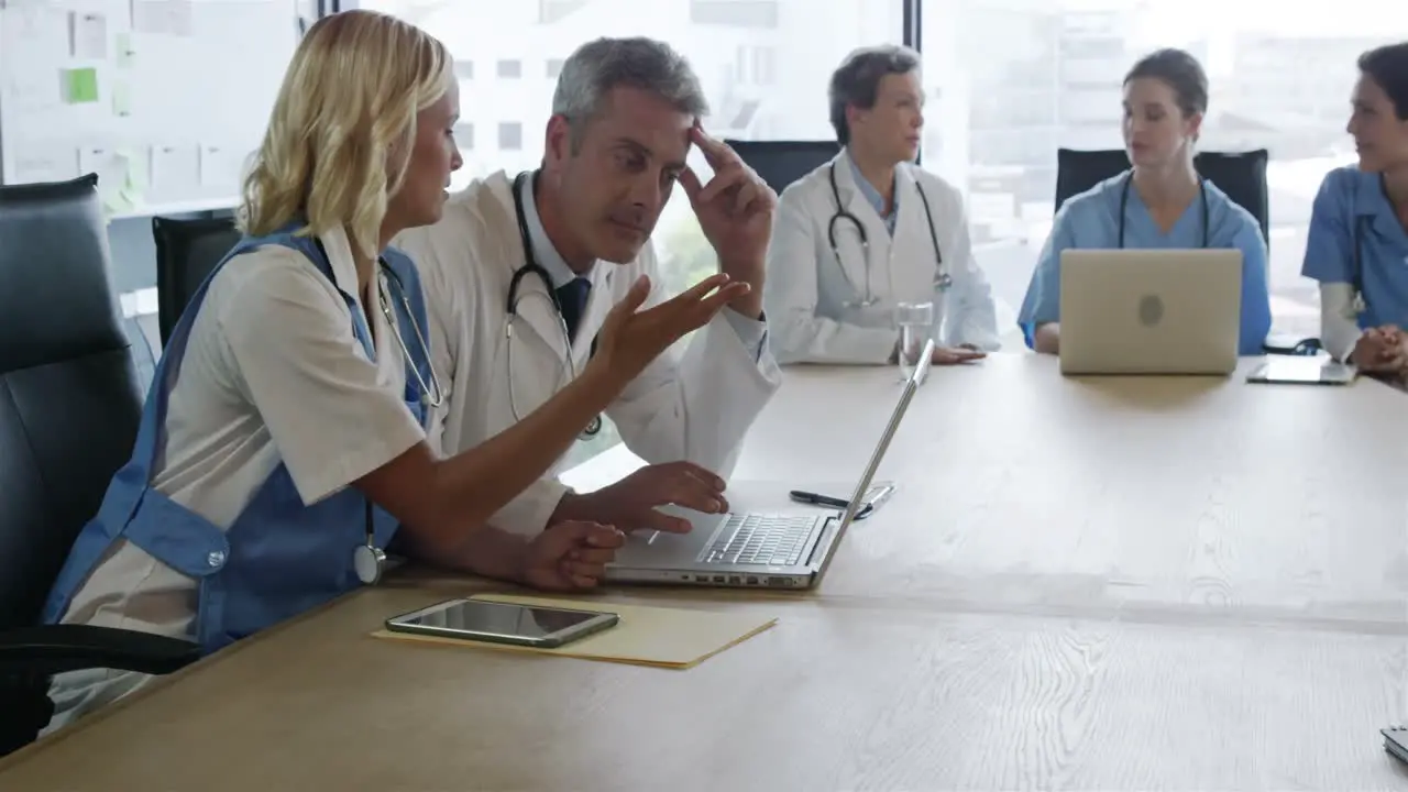 Concentrated doctors looking at laptop 