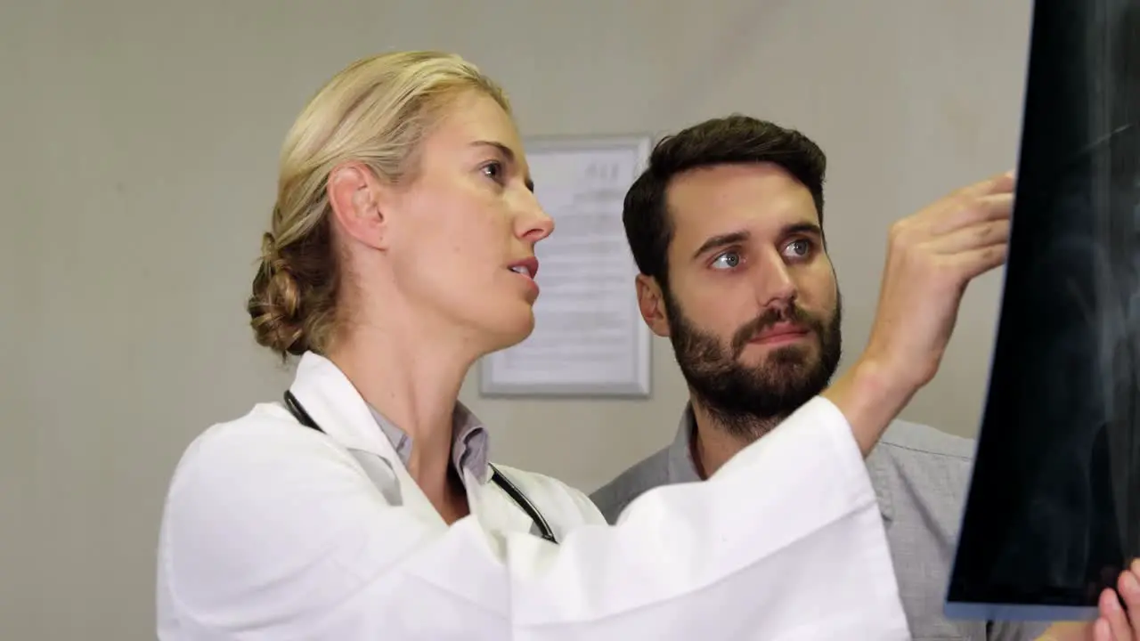 Physiotherapist explaining x-ray to patient