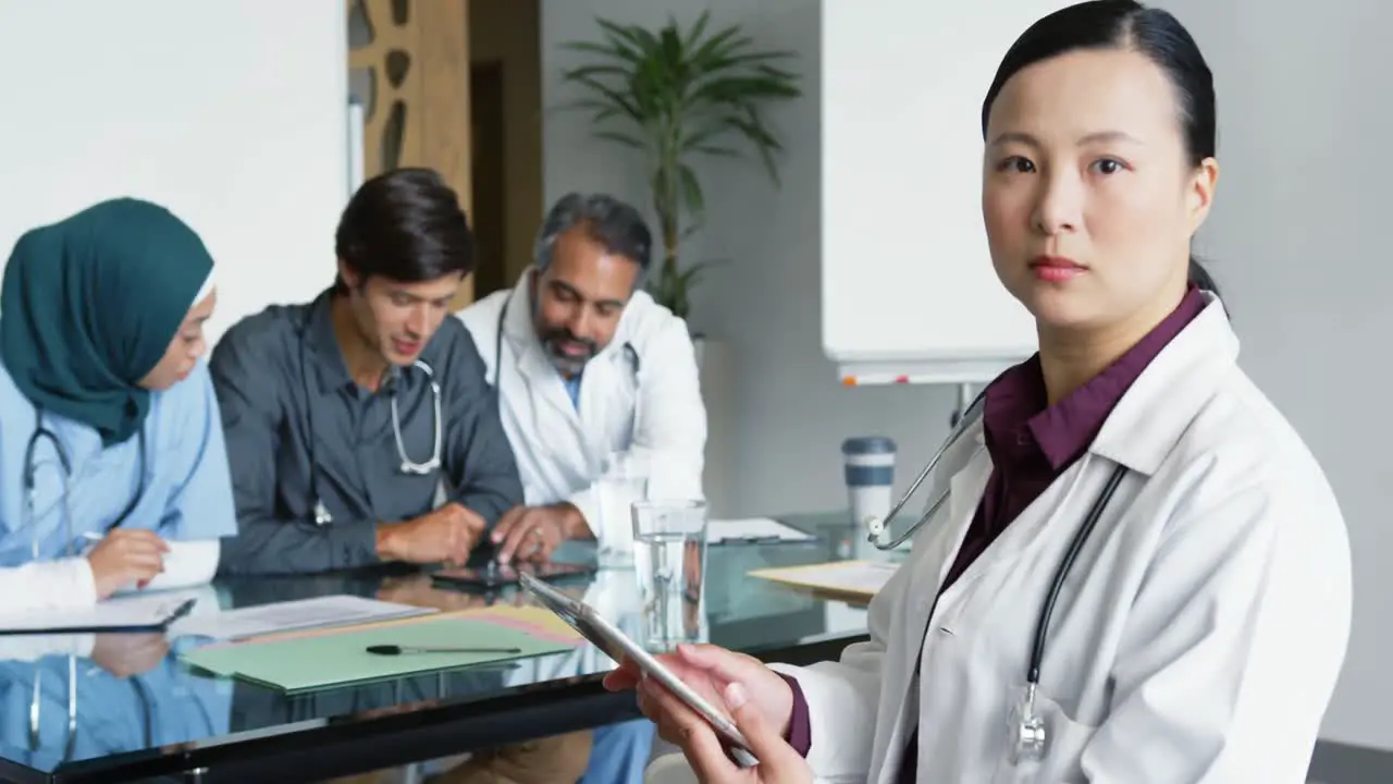 Female doctor using tablet in meeting 4k