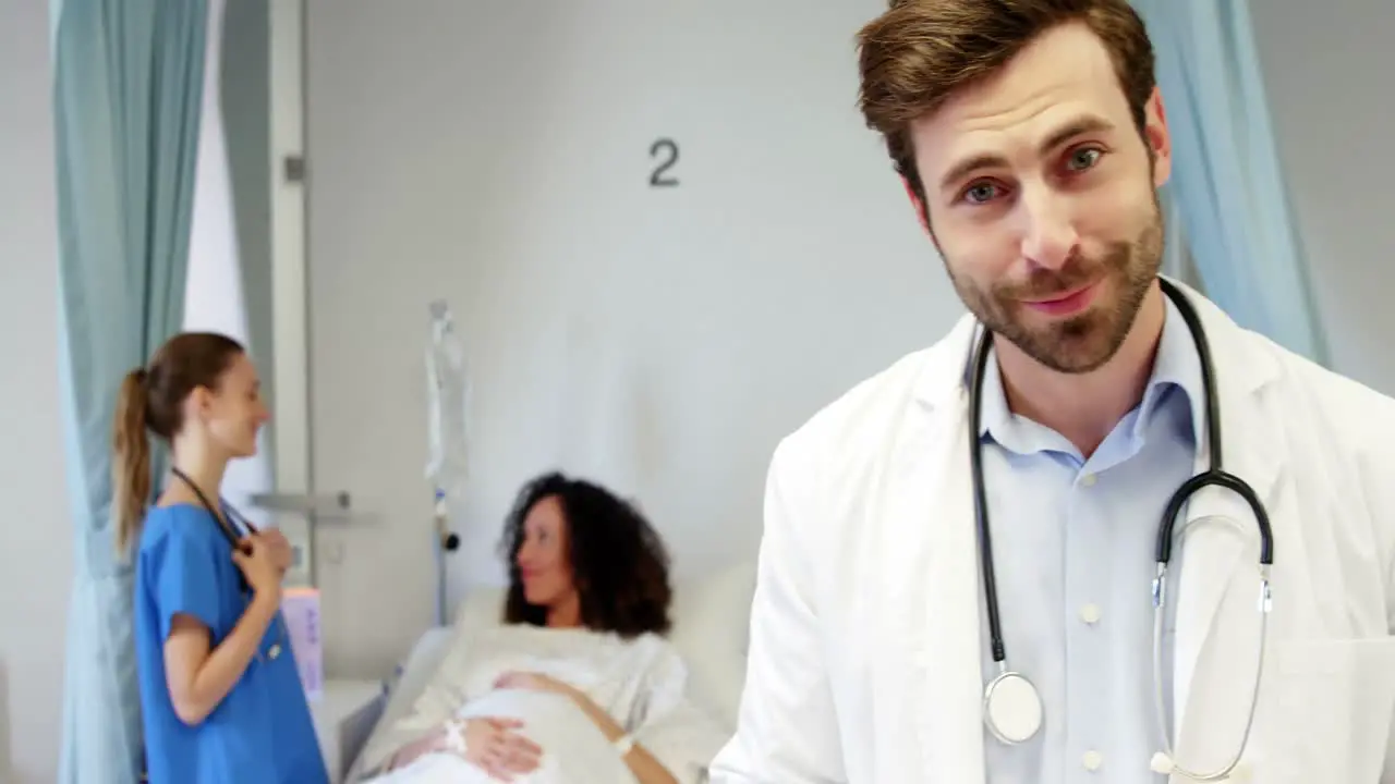 Portrait of smiling male doctor holding clipboard