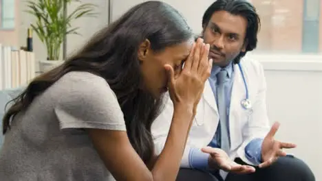 Young Woman Receives Difficult News from Doctor