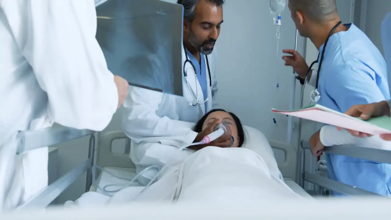 Doctors working together on patient in hospital bed 4k