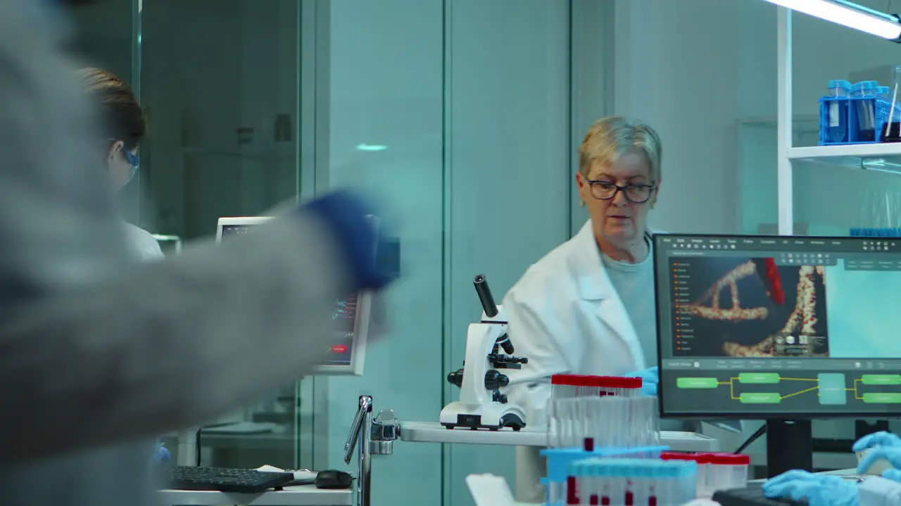 Chemist nurse typing on computer standing in lab