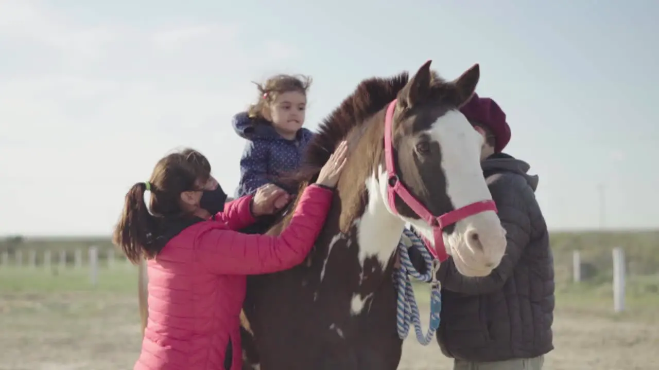 Young Girl Leans On The Horse With The Assistance Of Animal Trainers In Argentina